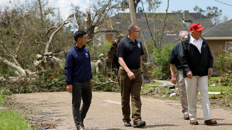 U.S. President Donald Trump accompanied by Department of Homeland Security (DHS) Secretary Chad Wolf and Federal Emergency Management Agency (FEMA) Administrator Pete Gaynor are seen during a visit to areas damaged by Hurricane Laura in Lake Charles, Louisiana, U.S., August 29, 2020. REUTERS/Tom Brenner