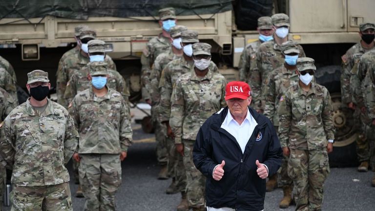 US President Donald Trump poses with National Guard troops in Lake Charles, Louisiana, on August 29, 2020. Trump surveyed damage in the area caused by Hurricane Laura. - At least 15 people were killed after Laura slammed into the southern US states of Louisiana and Texas, authorities and local media said on August 28. (Photo by ROBERTO SCHMIDT / AFP) (Photo by ROBERTO SCHMIDT/AFP via Getty Images)