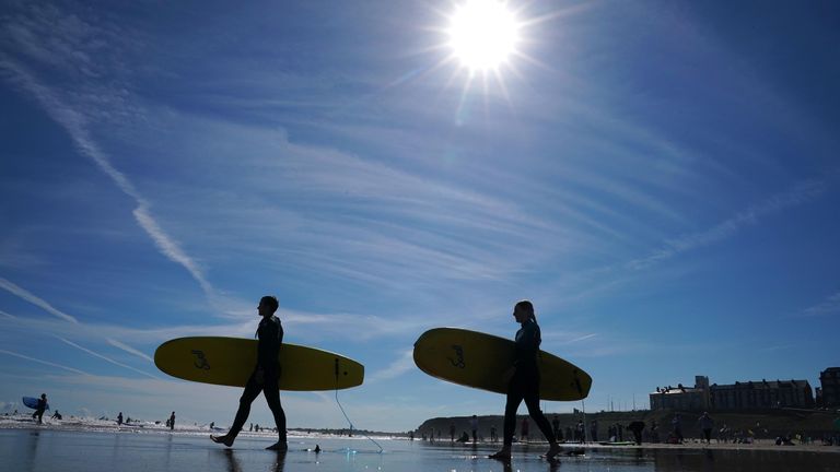 Surfers at the beach at Tynemouth as temperatures struggle to rise across the UK