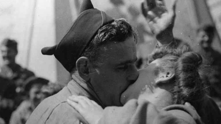 An American soldier and a British girl in London celebrated the end of the war with a kiss in Piccadilly Circus