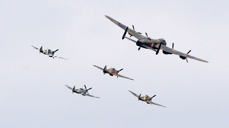 A Lancaster bomber, three Spitfires and a Hurricane perform a fly-past over the National Memorial Aroboretum on the 75th anniversary of VJ Day