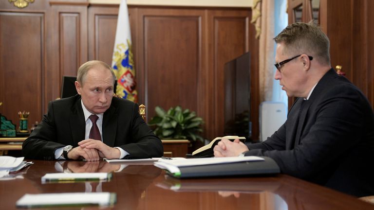 Russian President Vladimir Putin listens to minister of health Mikhail Murashko during a meeting on preventing the spread of coronavirus