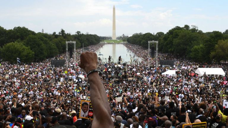 A participant raises his first during the "Commitment March: Get Your Knee Off Our Necks" protest against racism and police brutality on August 28, 2020, at the Lincoln Memorial in Washington, DC. - Anti-racism protesters marched on the streets of the US capital on Friday, after a white officer&#39;s shooting of African American Jacob Blake. The protester also marked the 57th anniversary of civil rights leader Martin Luther King&#39;s historic "I Have a Dream" speech delivered at the Lincoln Memorial. (