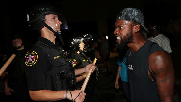 A man confronts police outside the Kenosha Police Department in Kenosha, Wisconsin, U.S., during protests following the police shooting of Black man Jacob Blake August 23, 2020. Picture taken August 23, 2020. Mike De Sisti/Milwaukee Journal Sentinel via USA TODAY via REUTERS MANDATORY CREDIT