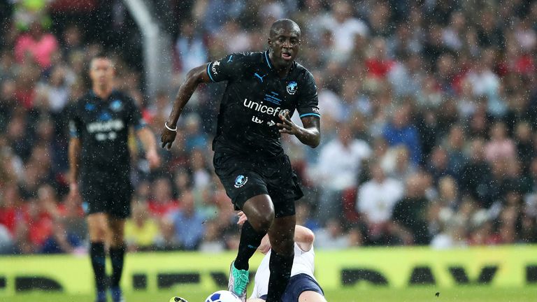 MANCHESTER, ENGLAND - JUNE 10:  Damian Lewis and Yaya Toure fight for the ball during the Soccer Aid for UNICEF 2018 match between England and The Rest of the World at Old Trafford on June 10, 2018 in Manchester, England. (Photo by Lynne Cameron/Getty Images)