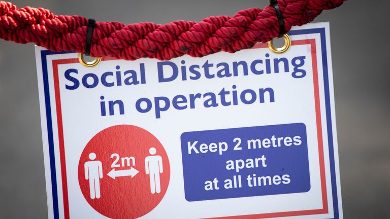 PORTHCAWL, UNITED KINGDOM - JUNE 24: A 2m social distancing sign at a cafe on June 24, 2020 in Porthcawl, United Kingdom. The First Minister of Wales Mark Drakeford has announced that all non-essential shops will be allowed to open their doors again in Wales from Monday but people will be asked to continue to "stay local" with five miles given as guidance until July 6. (Photo by Matthew Horwood/Getty Images)