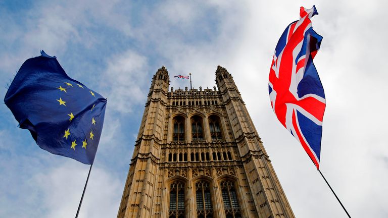 EU and Union flags flutter in the breeze in front of the Victoria Tower, part of the Palace of Westminster in central London on October 17, 2019. - Britain's Prime Minister Boris Johnson and the European Union on Thursday reached a provisional agreement that might just see Britain leave the European Union by the October 31 deadline. (Photo by Tolga AKMEN / AFP) (Photo by TOLGA AKMEN/AFP via Getty Images)