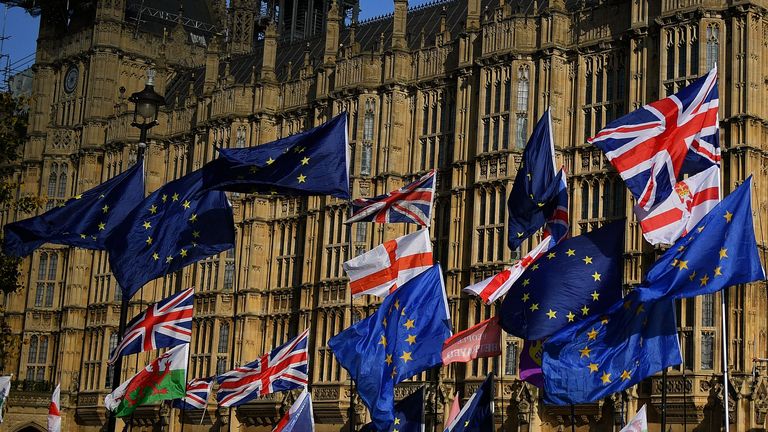 EU and Union flags belonging to both anti-Brexit and pro-Brexit activists, fly outside the Houses of Parliament in London on October 22, 2019, as MPs begin debating the second reading of the Government's European Union (Withdrawal Agreement) Bill. - British Prime Minister Boris Johnson faces two crucial Brexit votes Tuesday that could decide if he still has a reasonable shot at securing his EU divorce by next week's deadline. The UK is entering a cliffhanger finale to a drama that has divided families and embittered politics ever since voters backed a split from Britain's 27 EU allies and trading partners in 2016. (Photo by DANIEL LEAL-OLIVAS / AFP) (Photo by DANIEL LEAL-OLIVAS/AFP via Getty Images)