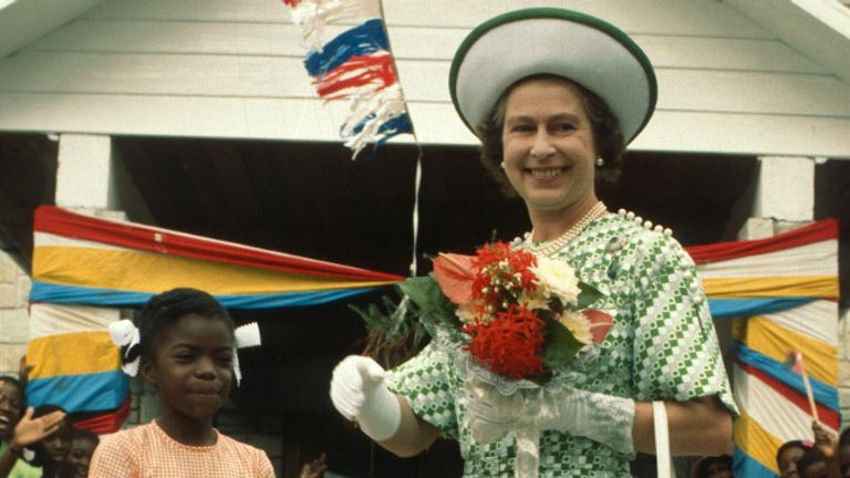 BARBADOS - NOVEMBER 01:  Queen Elizabeth ll smiles with a young girl in Barbados on November 01, 1977 in Barbados. (Photo by Anwar Hussein/Getty Images)