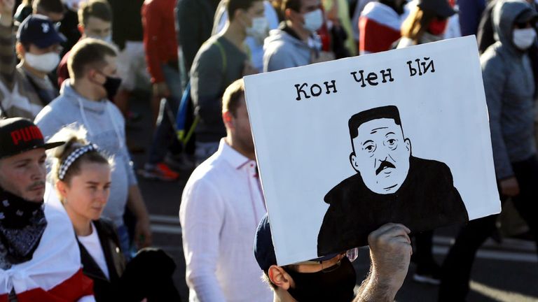 A man carries a placard depicting Belarus&#39; President as North Korean leader Kim Jong-un and reading "Washed-up" during a demonstration called by opposition movement for an end to the regime of authoritarian leader in Minsk on September 20, 2020 - Belarus President Alexander Lukashenko, who has ruled the ex-Soviet state for 26 years, claimed to have defeated opposition leader Svetlana Tikhanovskaya with 80 percent of the vote in the August 9, elections. (Photo by - / TUT.BY / AFP) (Photo by -/TUT