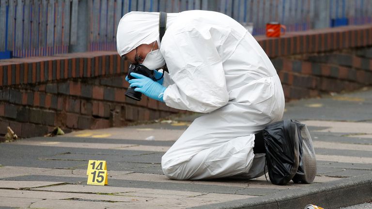 A forensic worker investigates at the scene of reported stabbings in Birmingham, Britain, September 6, 2020