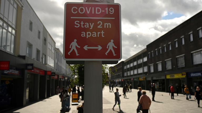 A sign urges people to stay 2m apart in Bolton, the worst-hit place for coronavirus in the country