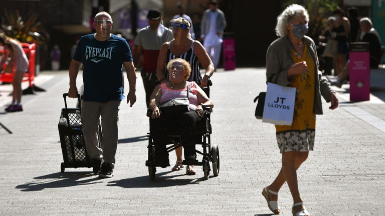  Shoppers wear face masks in Burnley town centre on July 31, 2020 in Burnley, England. Lockdown has been heightened in parts of England with a restriction ban for separate households in parts of northern England from meeting each other at home.