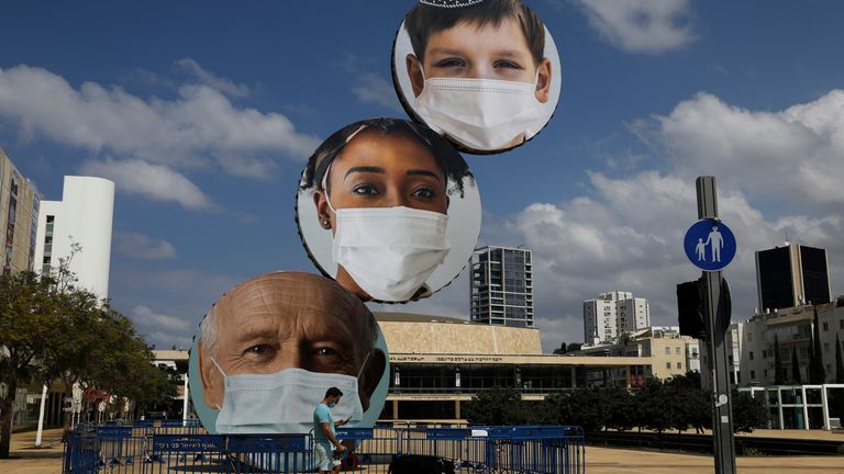 A statue in Tel Aviv, Israel, showing people wearing masks