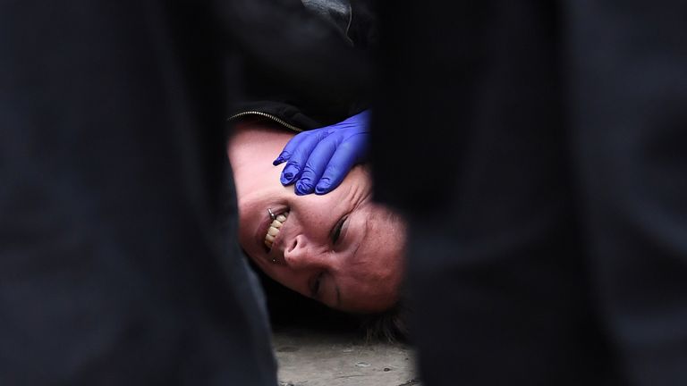 A protester on the ground at a &#39;We Do Not Consent&#39; rally at Trafalgar Square in London, organised by Stop New Normal, to protest against coronavirus restrictions.

