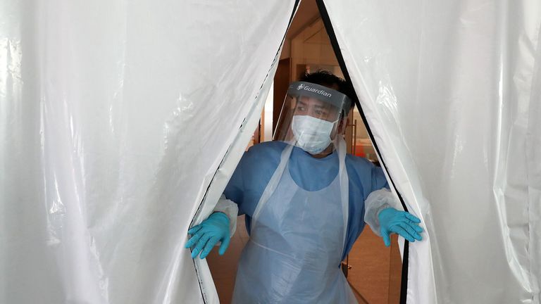 A laboratory technician wearing full PPE (personal protective equipment) works at a new Lighthouse Lab facility dedicated to testing for the novel coronavirus COVID-19, at Queen Elizabeth University Hospital in Glasgow on April 22, 2020. - The laboratory is part of a network of diagnostic testing facilities, along with other Lighthouse Lab sites in Milton Keynes and Cheshire, that will test samples from regional test centres around Britain where NHS staff and front-line workers with suspected Co