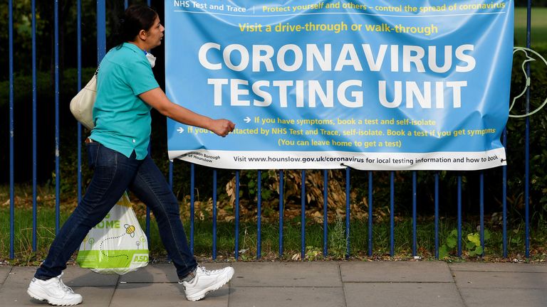 A person walks past a public health sign recommending testing following the outbreak of the coronavirus disease (COVID-19) in London, Britain September 16, 2020. REUTERS/Toby Melville