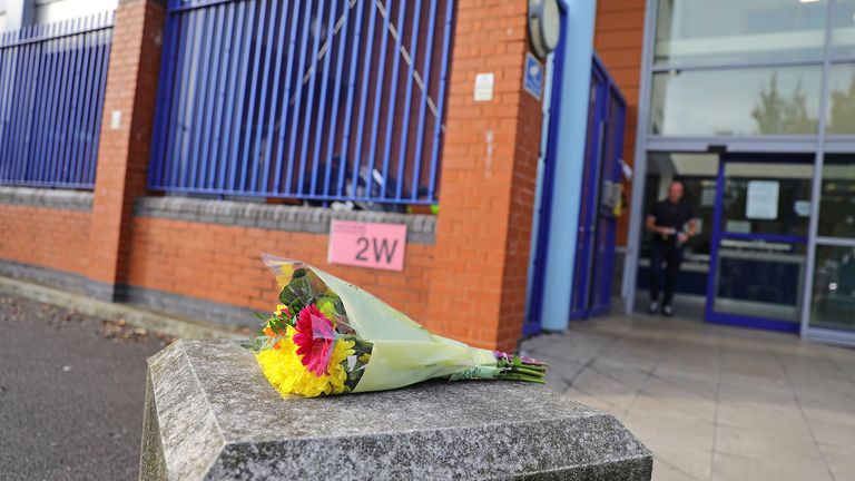 Flowers left outside Croydon Custody Centre in south London where a police officer was shot by a man who was being detained in the early hours of Friday morning. The officer was treated at the scene before being taken to hospital where he subsequently died.