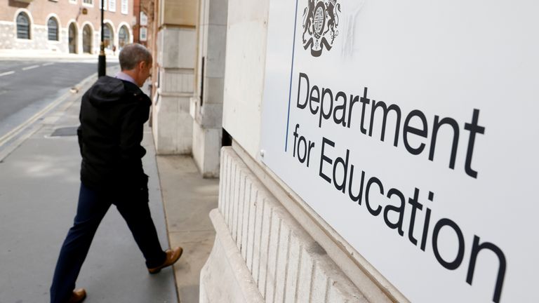 A man walks into the building of the Department for Education