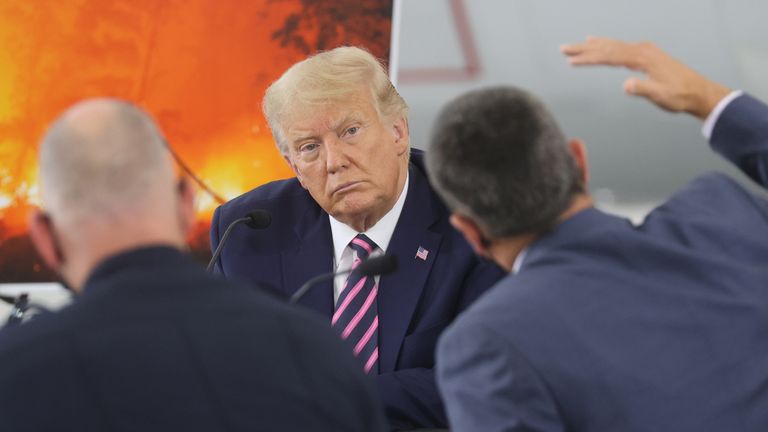 Donald Trump listens as Wade Crowfoot, California Secretary for National Resources, makes a point during a briefing on wildfires in California
