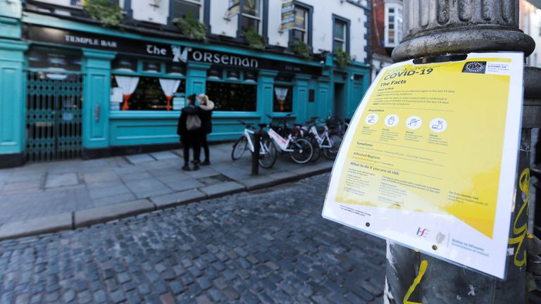 A notice about coronavirus is pictured as pub doors are locked in the Temple Bar area, as bars across Ireland close voluntarily to curb the spread of coronavirus, in Dublin, Ireland, March 15, 2020. REUTERS/Lorraine O&#39;Sullivan
