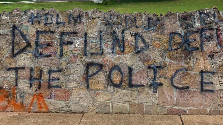 The words "Defund the police" were also sprayed on to the wall.  Pic: Briseida Holguin