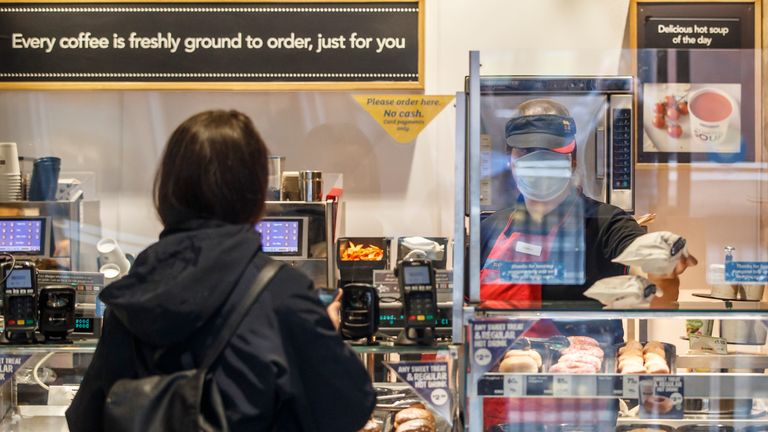A customer is served at Greggs in Leeds