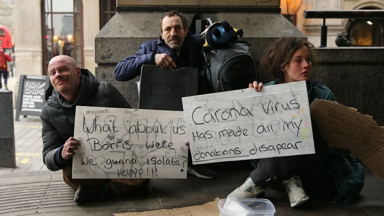 March: Homeless people hold up signs for help as the coronavirus crisis begins to escalate