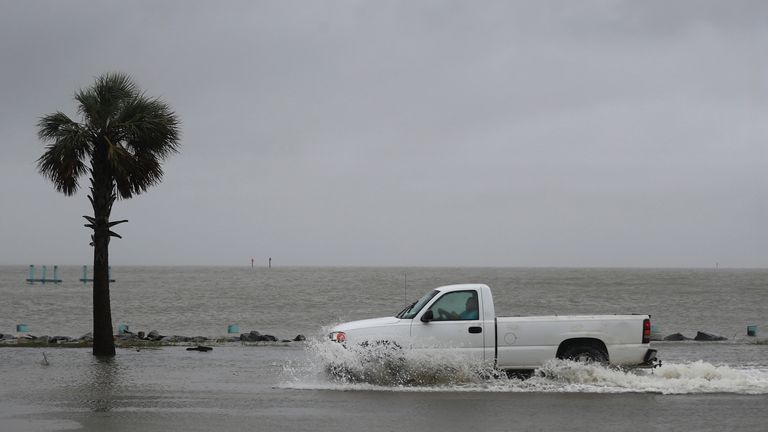 Hurricane Sally Makes Landfall On Gulf Coast
BAYOU LA BATRE, ALABAMA - SEPTEMBER 15: A driver navigates along a flooded road as the outer bands of Hurricane Sally come ashore on September 15, 2020 in Bayou La Batre, Alabama. The storm is threatening to bring heavy rain, high winds and a dangerous storm surge from Louisiana to Florida. (Photo by Joe Raedle/Getty Images)