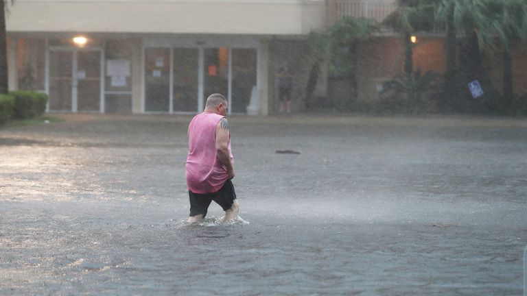 Hurricane Sally Makes Landfall On Gulf Coast
GULF SHORES, ALABAMA - SEPTEMBER 15: A man walks though a flooded parking lot as the outer bands of Hurricane Sally come ashore on September 15, 2020 in Gulf Shores, Alabama. The storm is bringing heavy rain, high winds and a dangerous storm surge from Louisiana to Florida. (Photo by Joe Raedle/Getty Images)