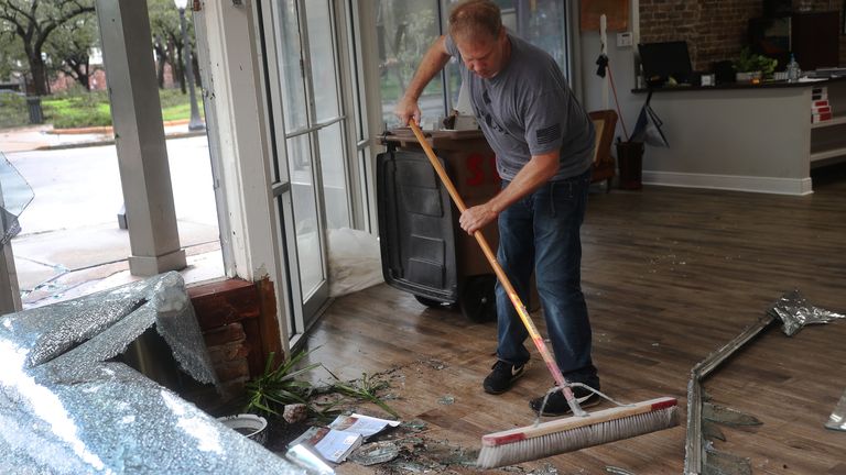 Hurricane Sally Makes Landfall On Gulf Coast
MOBILE, ALABAMA - SEPTEMBER 16: Morgan Griffin cleans up the broken window in the store he works in as Hurricane Sally passes through the area on September 16, 2020 in Mobile, Alabama. The storm is bringing heavy rain, high winds and a dangerous storm surge to the area. (Photo by Joe Raedle/Getty Images)