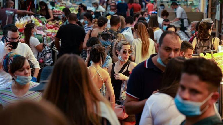 Shoppers are seen at a market in Jerusalem is coronavirus cases soared 