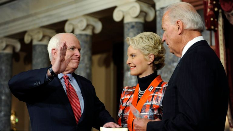 John McCain with his wife Cindy as he is sworn in by then vice-president Joe Biden in Washington in 2011