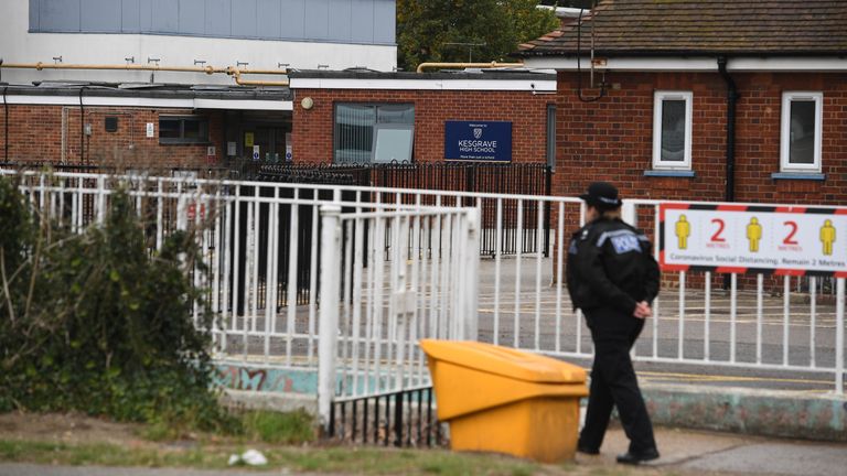 A police officer is pictured outside the victim&#39;s school in Kesgrave 