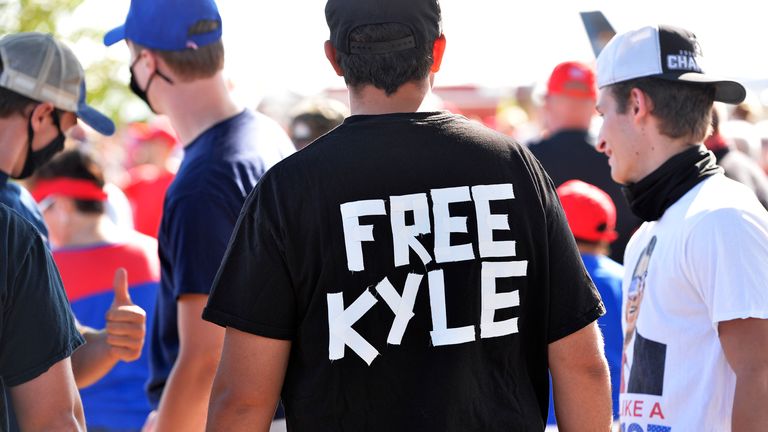 A man wearing a 'Free Kyle' T-shirt at a pro-Trump rally in New England