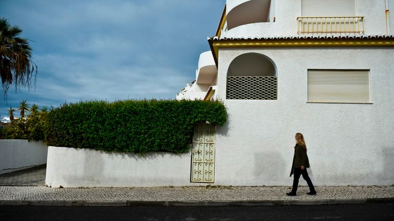 A woman passes by the former McCann&#39;s apartment at Praia da Luz