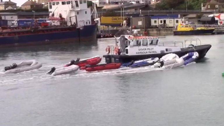 Empty dinghys being pulled by harbour patrol.