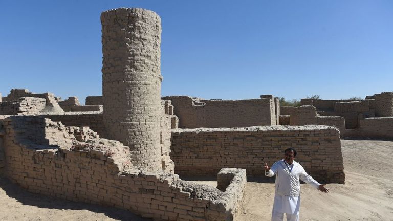 In this photograph taken on February 9, 2017, Pakistani caretaker at the UNESCO World Heritage archeological site of Mohenjo Daro, Ismail Mugheri, points out a two-story well used to collect drinking water at the site some 425 kms north of Karachi. Once the centre of a powerful civilisation, Mohenjo Daro was one of the world&#39;s earliest cities -- a Bronze Age metropolis boasting flush toilets and a water and waste system to rival modern standards. Some 5,000 years on archaeologists believe the ru