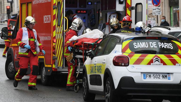 French firefighters load one of the several people injured into a waiting ambulance near the former offices of the French satirical magazine Charlie Hebdo following an alleged attack by a man wielding a knife in the capital Paris on September 25, 2020. - The threats coincide with the trial of 14 suspected accomplices of the perpetrators of the massacres at Charlie Hebdo and a Jewish supermarket that left a total of 17 dead. (Photo by Alain JOCARD / AFP) (Photo by ALAIN JOCARD/AFP via Getty Image