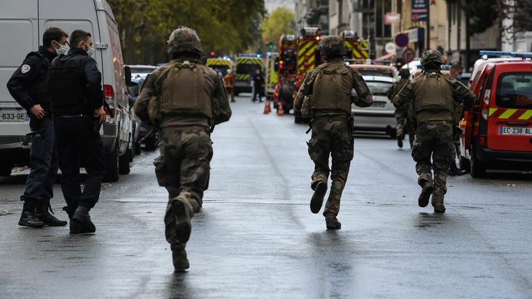 French soliders rush to the scene after several people were injured near the former offices of the French satirical magazine Charlie Hebdo following an alleged attack by a man wielding a knife in the capital Paris on September 25, 2020. - The threats coincide with the trial of 14 suspected accomplices of the perpetrators of the massacres at Charlie Hebdo and a Jewish supermarket that left a total of 17 dead. (Photo by Alain JOCARD / AFP) (Photo by ALAIN JOCARD/AFP via Getty Images)