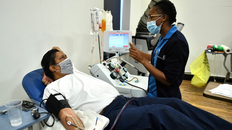 Aubrey Dhanraj, a plasma donor lies on reclining seat to give convalescent plasma for coronavirus treatment at a newly opened plasma donor centre in Twickenham, southwest London on June 11, 2020. - It is part of an ongoing trial to see if the antibodies in the plasma from survivors of COVID-19 can be used to treat those currently battling to recover from the virus. (Photo by Ben STANSALL / AFP) (Photo by BEN STANSALL/AFP via Getty Images)