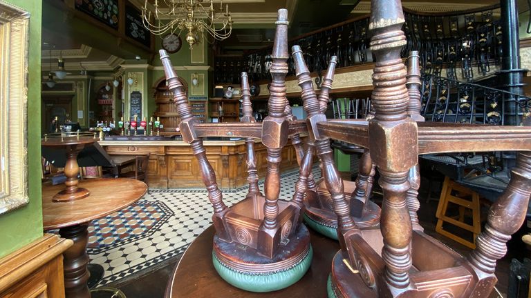 Upturned stools are seen on a table inside the Butchers Hook & Cleaver pub, owned by Fuller&#39;s, in London, Britain, July 3, 2020
