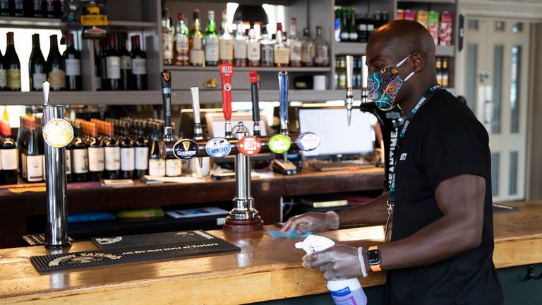 LONDON - JULY 04: An employe seen cleaning surfaces at The Lordship pub in East Dulwich on July 04, 2020 in London, England. The UK Government announced that Pubs, Hotels and Restaurants can open from Saturday, July 4th providing they follow guidelines on social distancing and sanitising. (Photo by John Phillips/Getty Images)