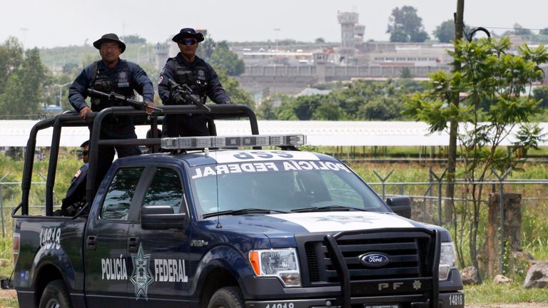 A unit of the Mexican Federal Police patrols the surroundings of the Puente Grande State prison (background) in Zapotlanejo, Jalisco State, Mexico