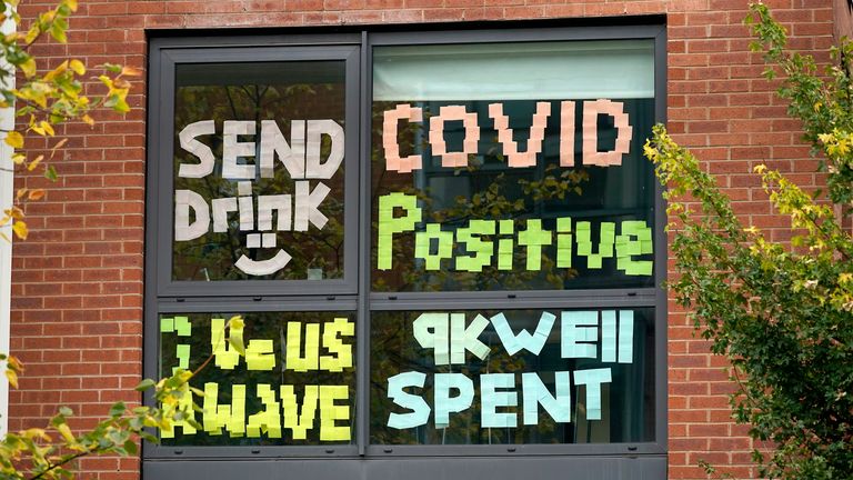 MANCHESTER, ENGLAND - SEPTEMBER 28: Signs made by students are displayed in a window of their locked down accommodation building on September 28, 2020 in Manchester, England. Around 1,700 students across two student housing blocks were told to self-isolate after more than 100 students recently tested positive for Covid-19. The students were told to self-isolate for 14 days even if they were not experiencing symptoms. (Photo by Christopher Furlong/Getty Images)