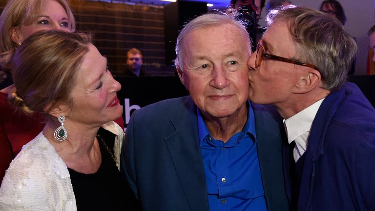 The designer (centre) is kissed by his son, Jasper, as wife Vicki looks on