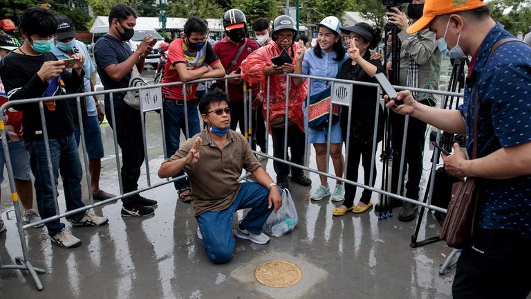 People take photos with a commemorative plaque placed by pro-democracy protest leaders