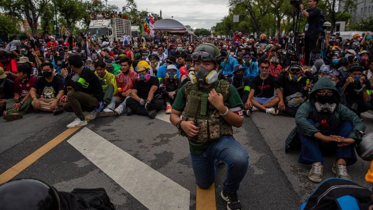 Anti-government protesters wearing protective glasses and masks take part in a protest