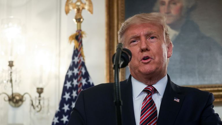 President Trump defends his coronavirus response, saying he sought to avoid panic