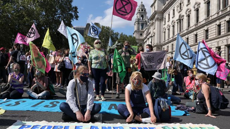 Extinction Rebellion activists sit in the road near Parliament Square
